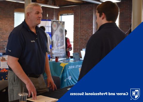 Student interacting with employer at UNH Manchester Career Fair