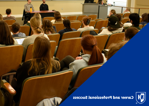 Students at a panel with CaPS logo in bottom left corner