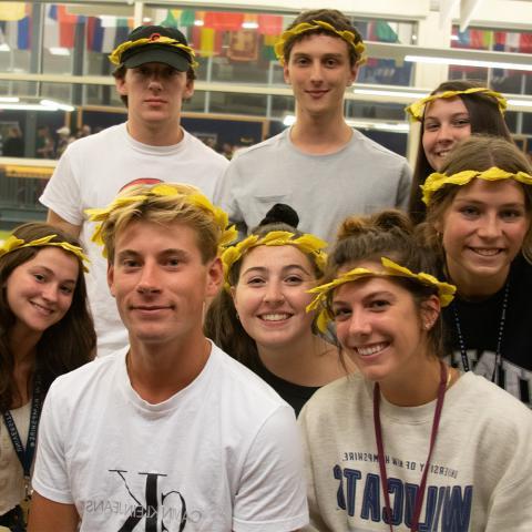 Students posing in a group with leaf crowns